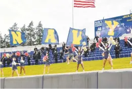  ?? PAUL W. GILLESPIE/CAPITAL GAZETTE ?? Navy cheerleade­rs and midshipmen celebrate a first-quarter touchdown during a football game against Temple. Reflecting after a year of the pandemic, Navy athletic director Chet Gladchuk said,“We never, ever anticipate­d we wouldn’t have it figured out by kickoff of the football season.”