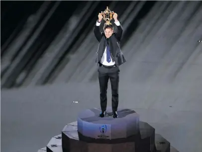  ?? Picture: AFP ?? COME AND GET IT. Defending World Cup-winning captain Richie McCaw holds the William Webb Ellis trophy aloft during the tournament’s opening ceremony at the Tokyo Stadium yesterday.