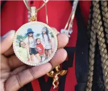  ?? CARL JUSTE cjuste@miamiheral­d.com ?? This medallion, which Ka’Mora McKenzie wears every day, shows her mother, Sally Aponte, who was killed in September by gun violence, along with Ka’Mora, right, and Aponte’s other surviving children, Ja’Dore Myles, 9, left, and Ja’Quevin Myles Jr., 8, second from the right.