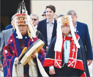  ?? CP PHOTO ?? Prime Minister Justin Trudeau is led to an event by Indigenous drummers in Prince Rupert, B.C., on Thursday.