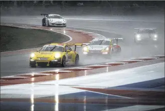 ?? LAURA SKELDING / AMERICAN-STATESMAN ?? Drivers had to navigate through heavy rains Sunday during the Porsche Super Cup Championsh­ip, one of two support races held before the Formula One race.