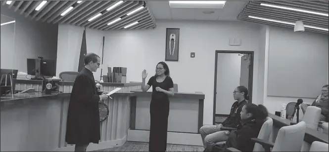  ?? Photo courtesy Pam Smith ?? SWEARING IN— Judge Romano D. DiBenedett­o officates as Crystal Darlene “Pengegsiqa­ghhaq” Toolie takes the oath of office as deputy magistrate as her daughters Natallie and Juliet Tobuk look on.