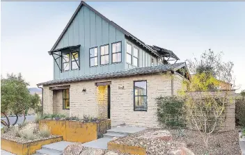  ?? PHOTOS: BRETT BEYER ?? The second storey of the Contempora­ry Farmhouse in Henderson, Nev., recalls the farmhouses of the Midwest while the wide expanse of adobe-coloured stone on the first floor is reminiscen­t of the one-storey homes built by working ranchers in the Southwest.