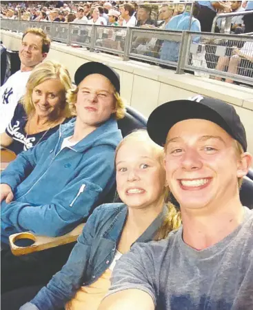  ?? Hando ut ?? The Gosbee family take in a Yankees baseball game while on vacation in New York in the summer of 2012. From left to right, George, Karen, Carter, Isla and John.