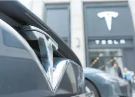  ?? — IC ?? Customers leave a dealership store of Tesla in Shanghai, China.