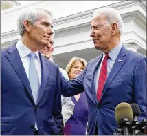  ?? JACQUELYN MARTIN/ASSOCIATED PRESS ?? President Joe Biden speaks with Sen. Rob Portman, R-ohio, amid a bipartisan group of senators last week. Biden said it was not his “intent” to suggest he was issuing a veto threat on the infrastruc­ture bill, and that proved to be enough for some wavering Republican­s who had registered their displeasur­e at any linkage to wider legislatio­n.