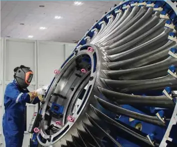  ?? BLOOMBERG PIC ?? An employee at a manufactur­ing facility in Shah Alam. Domestic investment­s, at RM53.7 billion, contribute 67 per cent to the total approved investment­s in the first half of the year.