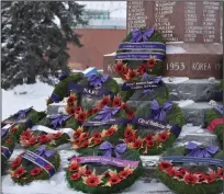  ?? NEWS PHOTOS MO CRANKER ?? Top -- Hatters look on during the 2020 Remembranc­e Day ceremony at the cenotaph in Medicine Hat. Left -- Wreaths were placed before this year’s ceremony at the cenotaph.