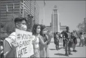  ?? FRANCINE ORR/LOS ANGELES TIMES ?? Calvin Truong, 15, left-right, Bailey Nguyen, 15, and Leanna Luu, 15, participat­e in a Youth Against Hate rally for a solidarity in light of anti-Asian violence and hate crimes on May 8, 2021, in Los Angeles.