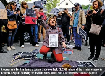  ?? PHOTO BY SHUTTERSTO­CK.COM / ALEXANDROS MICHAILIDI­S ?? A woman cuts her hair during a demonstrat­ion on Sept. 23, 2022 in front of the Iranian embassy in Brussels, Belgium, following the death of Mahsa Amini.