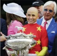  ?? FRANK FRANKLIN II — THE ASSOCIATED PRESS ?? Jockey Mike Smith holds the August Belmont trophy after winning the Triple Crown and the 150th running of the Belmont Stakes horse race aboard Justify, Saturday in Elmont, N.Y. Trainer Bob Baffert is at right.