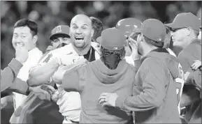  ?? Sean M. Haffey Getty Images ?? ALBERT PUJOLS finds himself in the middle of a celebratio­n after driving in the winning run in the Angels’ 4-3 victory over the Texas Rangers.