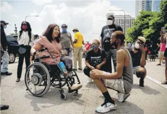  ?? PAT NABONG/SUN-TIMES ?? U.S. Sen. Tammy Duckworth talks with William Hooks, 24, before a march to commemorat­e Juneteenth in downtown Chicago on June 19.