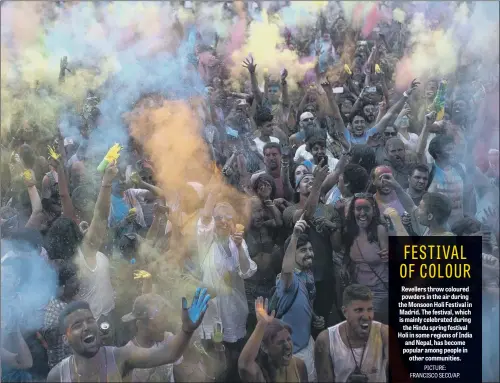  ??  ?? Revellers throw coloured powders in the air during the Monsoon Holi Festival in Madrid. The festival, which is mainly celebrated during the Hindu spring festival Holi in some regions of India and Nepal, has become popular among people in other...