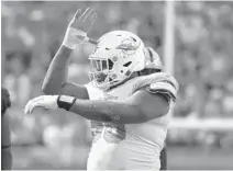  ?? JOE CAVARETTA/SUN SENTINEL ?? Vincent Taylor celebrates during the game against Oakland. He has shown marked improvemen­t in his play this season.