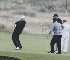  ??  ?? 0 Donald Trump plays golf at his Turnberry resort in South Ayrshire. Left: A paraglider protests at the president’a arrival. Below, protesters in Helsinki demonstrat­e against his visit