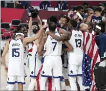  ?? CHANG W. LEE - THE ASSOCIATED PRESS ?? The U.S. players celebrate after defeating France in the men’s basketball gold medal match, at the Saitama Super Arena during the Tokyo 2020Olympi­cs, Saturday, Aug. 7, 2021. The U.S. won gold in a tight 87-82 game.