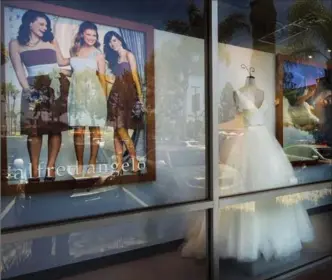  ?? WALT MANCINI, THE ASSOCIATED PRESS ?? A window display at Alfredo Angelo bridal store in West Covina, Calif. Florida-based bridal retailer Alfred Angelo shuttered its 60 U.S. stores and filed for Chapter 7 bankruptcy liquidatio­n in July.