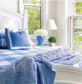  ??  ?? |BELOW| GET THE CHECK. A happy shade of blue enlivens the main bedroom. “I like the colors I use inside to be a reflection of the seasonal ones we are seeing through the windows,” Janice says.