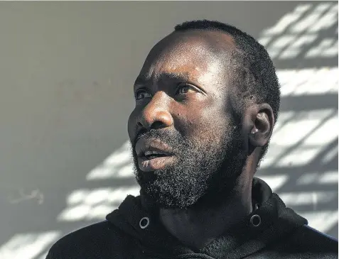  ??  ?? Nigerian migrant Osas Akahomoen in the lice-ridden Tripoli detention centre where he is being held incommunic­ado