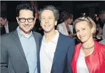 ?? Photograph­s by Alex J. Berliner ABImages ?? BRIAN GRAZER, center, shown with J.J. Abrams and Gabrielle Carteris, hosts a Ghetto Film School benefit at his home.
