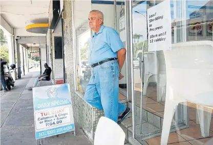  ?? /Reuters ?? Had his chips: A worker at a fish and chips shop waits stoically for another bout of Eskom’s load-shedding to come to an end in Durban this Tuesday.