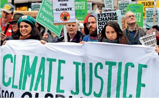  ??  ?? December 1, 2018: Climate change protesters demonstrat­e in London before the United Nations climate change conference is held in Poland. VCG