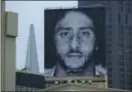  ?? ERIC RISBERG - THE ASSOCIATED PRESS ?? A large billboard stands on top of a Nike store showing former San Francisco 49ers quarterbac­k Colin Kaepernick at Union Square, Wednesday in San Francisco.