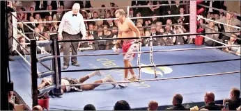  ??  ?? Mitt Romney stands over Evander Holyfield after knocking him down