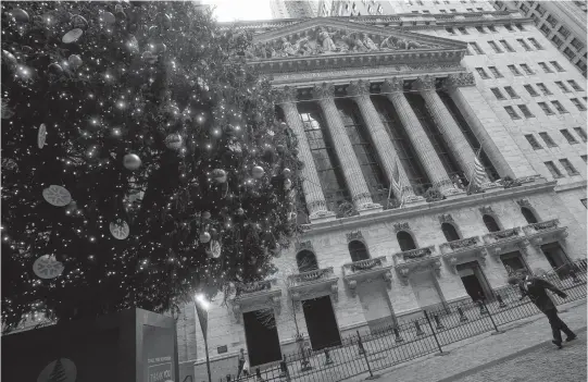  ?? CARLO ALLEGRI • REUTERS ?? A Christmas tree outside the New York Stock Exchange in New York City.