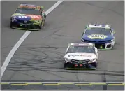  ?? CHARLIE RIEDEL — THE ASSOCIATED PRESS ?? Denny Hamlin, front right, beat Chase Elliott, back right, and Kyle Busch to the finish line and won Sunday’s NASCAR Cup Series race at Kansas Speedway.