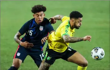  ?? AP Photo/Ronald Zak ?? USA’s Chris Richards (left) duels for the ball with Jamaica’s Andre Gray during the internatio­nal friendly soccer match between USA and Jamaica at SC Wiener Neustadt stadium in Wiener Neustadt, Austria, on Thursday.