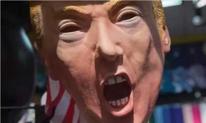  ??  ?? A Halloween mask depicting Donald Trump. Photograph: Saul Loeb/AFP/Getty Images