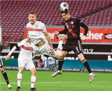  ?? PIC AFP ?? Stuttgart’s Waldemar Anton (left) and Bayern Munich’s Robert Lewandowsk­i vie for the ball during their Bundesliga match on Saturday.