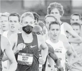  ?? Associated Press file ?? A runner wears a mask for allergies during the U.S. track and field championsh­ips in Eugene, Ore. A report issued Monday listed how global warming will make the air dirtier, water more contaminat­ed and food more tainted.