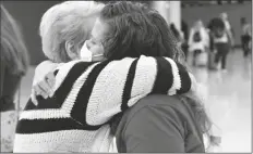  ?? THOMAS PEIPERT/AP ?? JOCELYN RAGUSIN HUGS HER MOTHER, who arrived at Denver Internatio­nal Airport from Rapid City, South Dakota, on Tuesday.