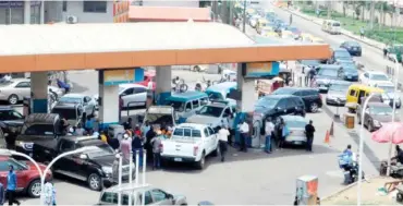  ?? Photo: Benedict Uwalaka ?? Motorists on queue to buy fuel at a filling station in Ikeja, Lagos, yesterday