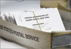  ?? AP file photo ?? A box of absentee ballots waits to be counted at the Albany County Board of Elections in Albany, N.Y., in June. Mail-in ballots have exploded in popularity since the pandemic spread in mid-March, at the peak of primary season.