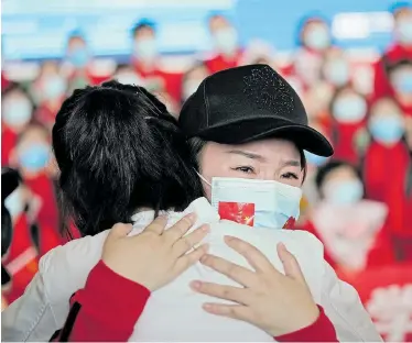  ?? Picture: ALY SONG/REUTERS ?? AT LAST: A medical worker reacts at the Wuhan Tianhe Internatio­nal Airport yesterday after travel restrictio­ns to leave Wuhan, China's epicentre of the Covid-19 outbreak, were lifted