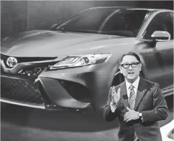  ?? CARLOS OSORIO, AP ?? Toyota President Akio Toyoda unveils the 2018 Camry in January. Toyoda, who is grandson of Toyota’s founder, wants cars to be fun — he loves racing them and working on them.