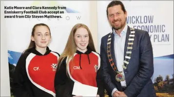  ??  ?? Katie Moore and Ciara Kennedy from Enniskerry Football Club accept an award from Cllr Steven Matthews.