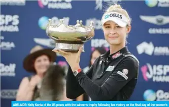  ?? — AFP ?? ADELAIDE: Nelly Korda of the US poses with the winner’s trophy following her victory on the final day of the women’s LPGA Tour-sanctioned Australian Open golf championsh­ip at the Grange Golf Club in Adelaide yesterday.