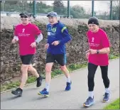  ??  ?? Willie Cody and Maurice Tobin joined by veteran runner, Tony Dunne on the 50km charity run around St Colman’s walking track.