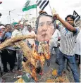  ??  ?? Silenced: once lauded as a defender of democracy, Suu Kyi, top, is now the subject of protests