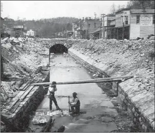  ?? Submitted photo ?? TUNNEL HISTORY: Workmen construct the Hot Springs Creek Tunnel, also called “Hamblen’s Arch,” in 1883-1884. This photo looks north across present-day Reserve Street. Jerry Butler will tell the story of the historic tunnel at the noon Tuesday meeting of...