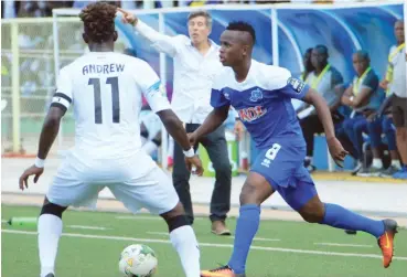  ??  ?? Enyimba's Andrew Abalogu and Prosper Dunk of Rayon Sports fight for the ball during the first leg of their CAF Confederat­ion Cup quarter-final match