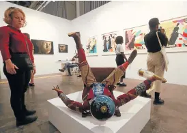  ?? /Sunday Times ?? Pause for thought: Yinka Shonibare’s sculpture, Champagne Kid (Fallen), attracted a lot of attention at the Cape Town Art Fair in February.