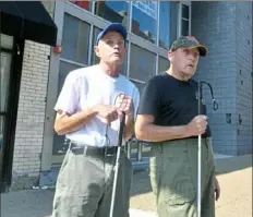  ?? Nate Guidry/Post-Gazette ?? Twin brothers Jimmy, left, and Larry Wiseman, 67, wait Sept. 11 for the Port Authority Transit bus along Liberty Avenue en route from Bloomfield to Oakland. Video at post-gazette.com.