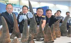  ?? RUNGROJ YONGRIT, EUROPEAN PRESSPHOTO AGENCY ?? Thai customs officers display seized rhino horns Tuesday at Suvarnabhu­mi Airport on the outskirts of Bangkok. The horns, worth $4.9 million, were hidden inside a suitcase on a flight from Addis Ababa, Ethiopia. Two Thai women are believed to be...