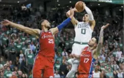  ?? ELISE AMENDOLA — THE ASSOCIATED PRESS ?? Boston Celtics forward Jayson Tatum (0) shoots against Philadelph­ia 76ers guard Ben Simmons (25) and guard JJ Redick (17) in the second half of Game 1 of an NBA basketball second-round playoff series, Monday in Boston.